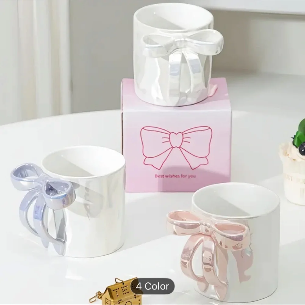 RIBBON HANDLE CUP NEW IN BEAUTIFUL PACKAGE. NIB PINK WHITE AND PURPLE AVAIL